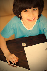 Image showing smiling child doing homework