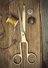 Image showing vintage dressmaker scissors, bobbin of thread and buttons