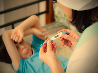 Image showing digital thermometer in the hands of a doctor