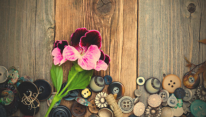 Image showing vintage buttons with a geranium flower