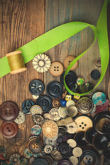 Image showing vintage buttons with green ribbon and spool with thread