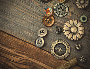 Image showing vintage buttons on the aged wooden boards