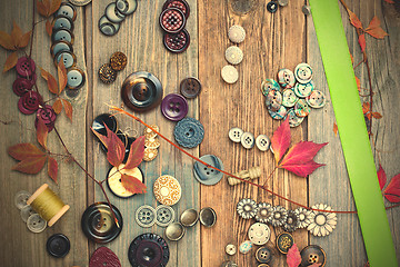 Image showing vintage buttons, reel with thread, herbarium and green tape