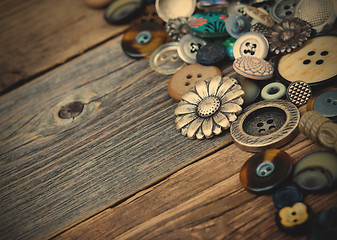 Image showing buttons in large numbers scattered on aged wooden boards