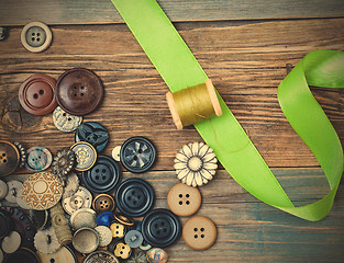 Image showing spool with thread, vintage buttons and green tape