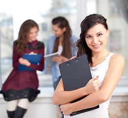 Image showing smiling  girl looking at camera in college