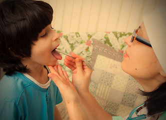 Image showing boy showing his throat to doctor