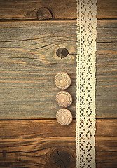 Image showing Three vintage bone buttons and lace tape