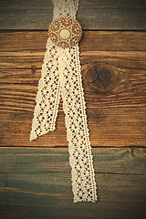 Image showing vintage lace with a brooch