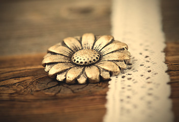 Image showing vintage metal button flower and lace ribbon