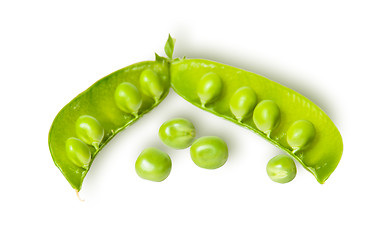 Image showing Opened green pea pod and several peas