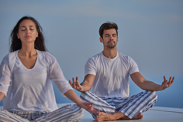 Image showing young couple practicing yoga