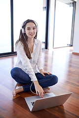 Image showing relaxed young woman at home working on laptop computer