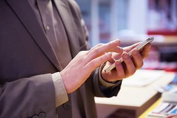 Image showing business man working on phone at office