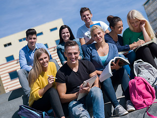 Image showing students outside sitting on steps