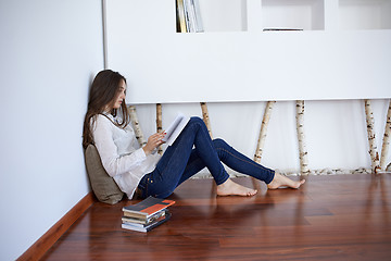 Image showing relaxed young woman at home working on laptop computer