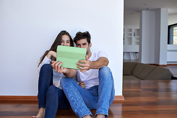 Image showing couple at modern home using tablet computer