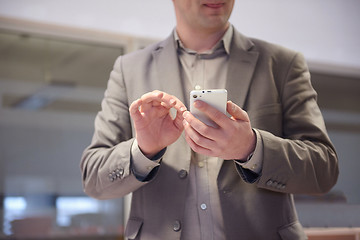 Image showing business man working on phone at office