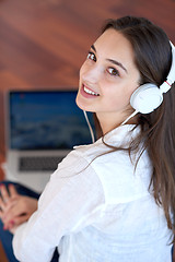 Image showing relaxed young woman at home working on laptop computer