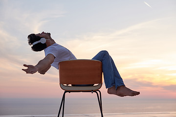 Image showing relaxed young man at home on balcony