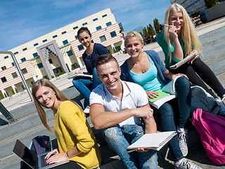 Image showing students outside sitting on steps