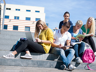 Image showing students outside sitting on steps