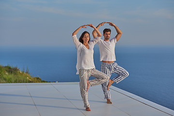 Image showing young couple practicing yoga