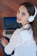 Image showing relaxed young woman at home working on laptop computer