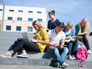 Image showing students outside sitting on steps