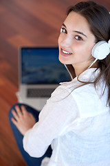 Image showing relaxed young woman at home working on laptop computer