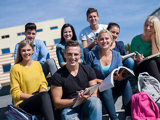 Image showing students outside sitting on steps