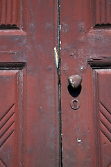 Image showing  brass brown knocker and wood   vinago  varese italy