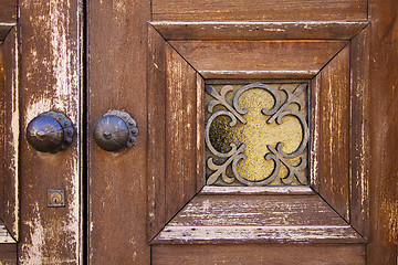 Image showing brass brown knocker and wood    caronno varesino varese  