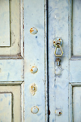 Image showing abstract cross   brass brown knocker in   venegono  varese italy