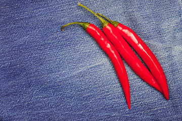 Image showing red chili pepper on jeans background