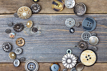 Image showing several old buttons on the vintage table surface