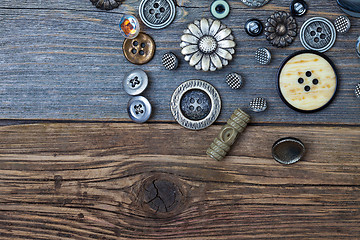 Image showing Vintage buttons on the old wooden surface