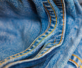 Image showing age Jeans with yellow stitching thread
