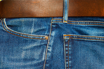 Image showing blue jeans with belt, close up