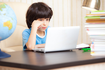 Image showing boy looking at a computer monitor
