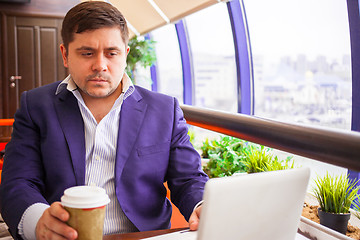 Image showing businessman watching stock quotes