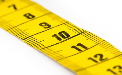 Image showing Yellow measuring tape isolated - selective focus