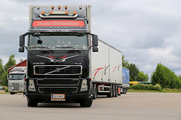 Image showing Black Volvo FH16 Leaving Truck Stop