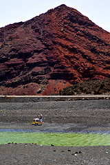 Image showing people dog stone  ocean sky  water lanzarote in el golfo   