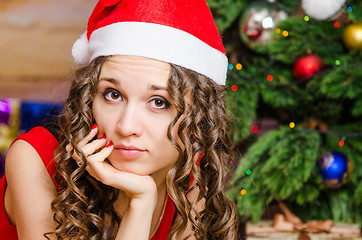 Image showing Portrait of pensive girl in a Christmas setting