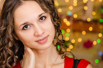 Image showing Portrait girl on a background of blurred Christmas lights