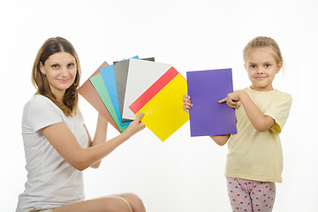 Image showing girl and girl are holding colorful monochrome images