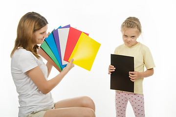 Image showing Upset girl holding a black picture