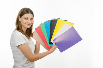 Image showing young girl holding a picture with solid colors