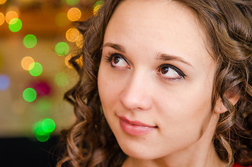 Image showing Portrait a young girl on the background of Christmas lights